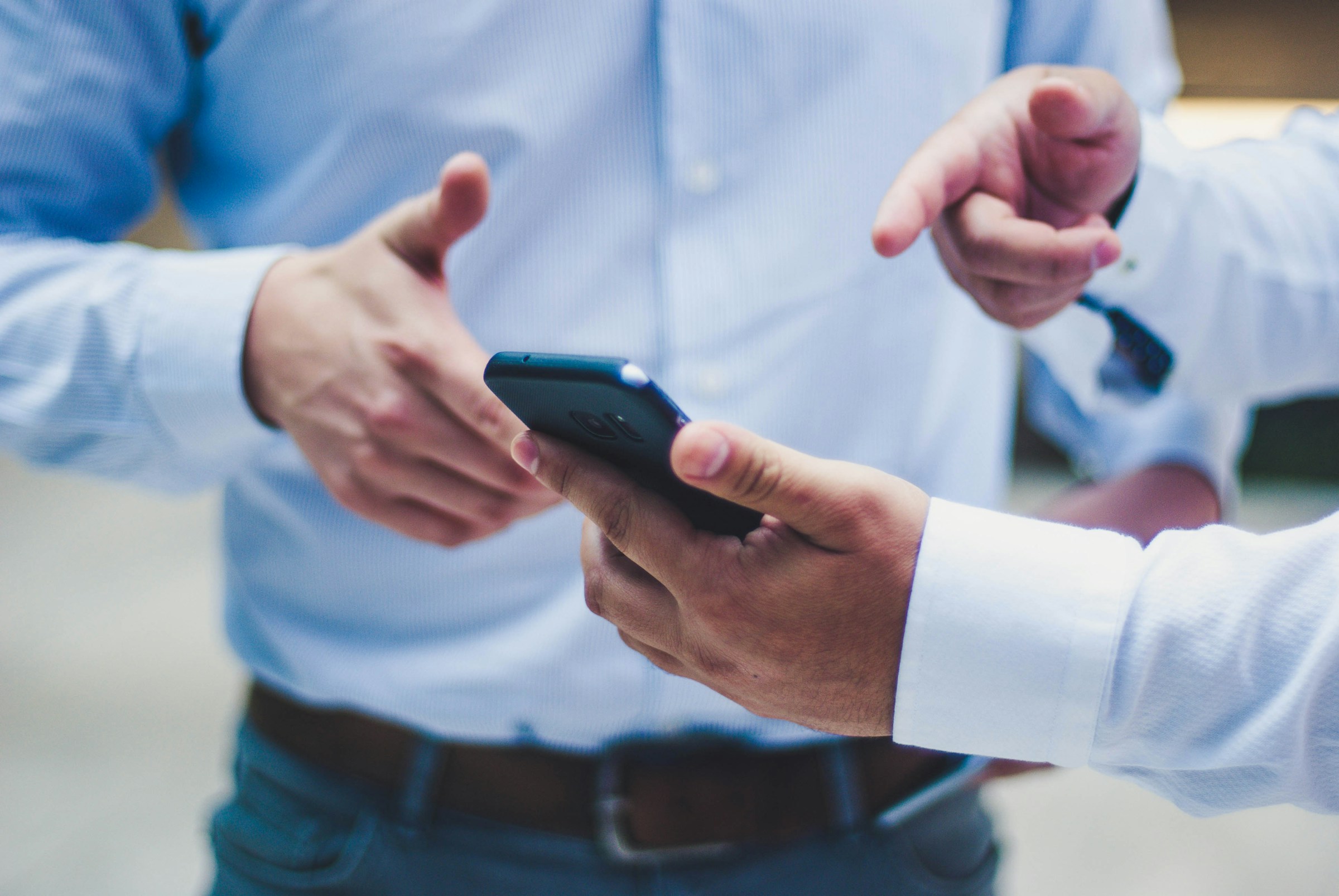 Person Pointing at Mobile - Best AI Answering Service