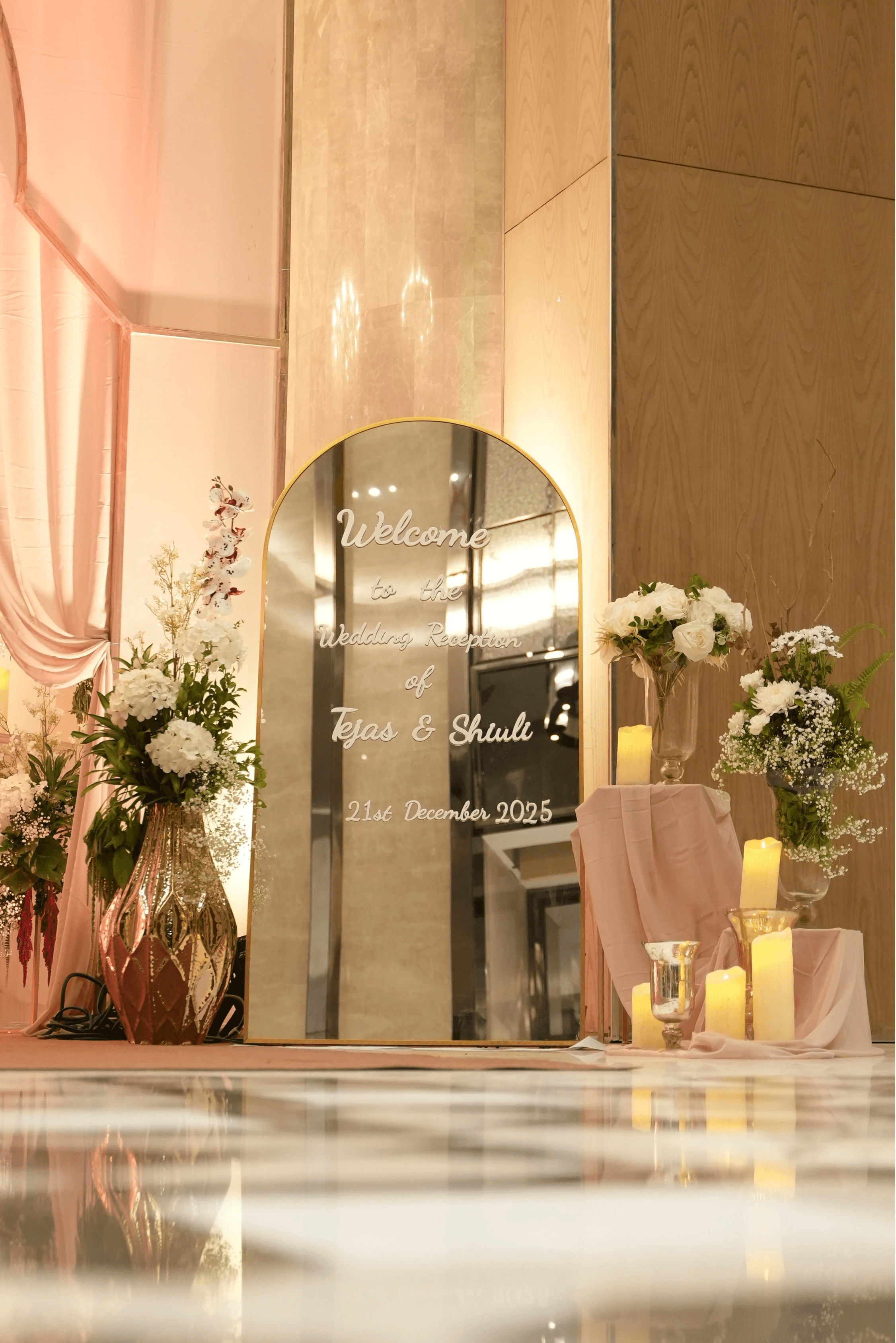 A bride and groom share a kiss surrounded by a joyful bridal party.