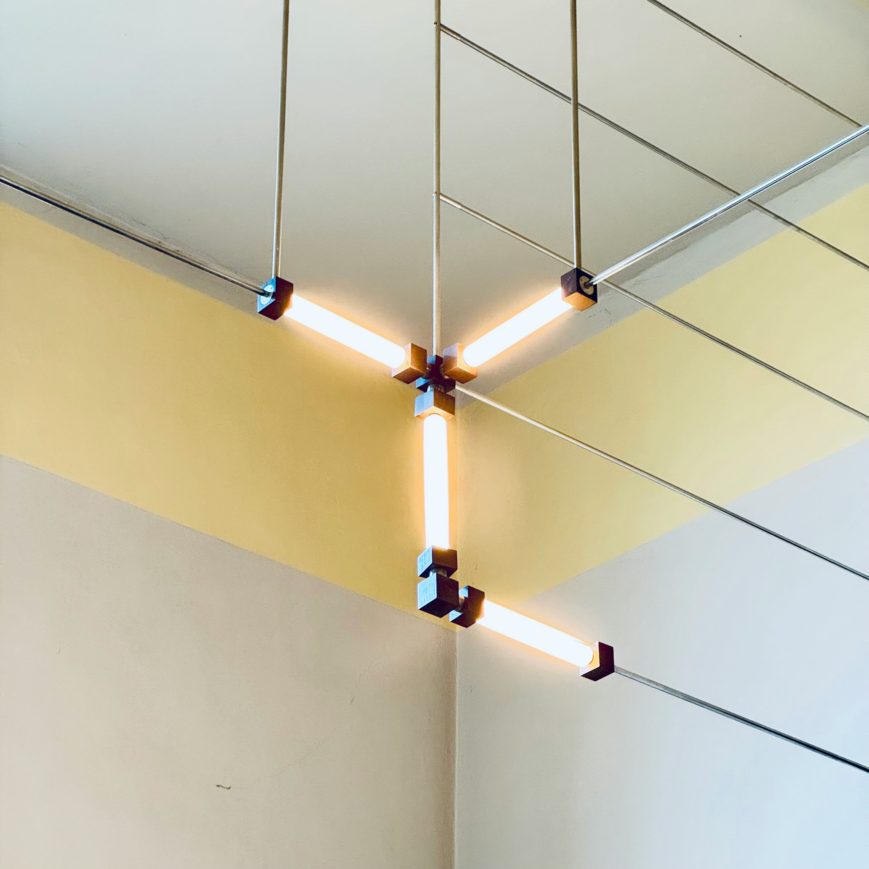 Modern light fixture with glowing tubes by tawridat al hadaf riyadh, ksa