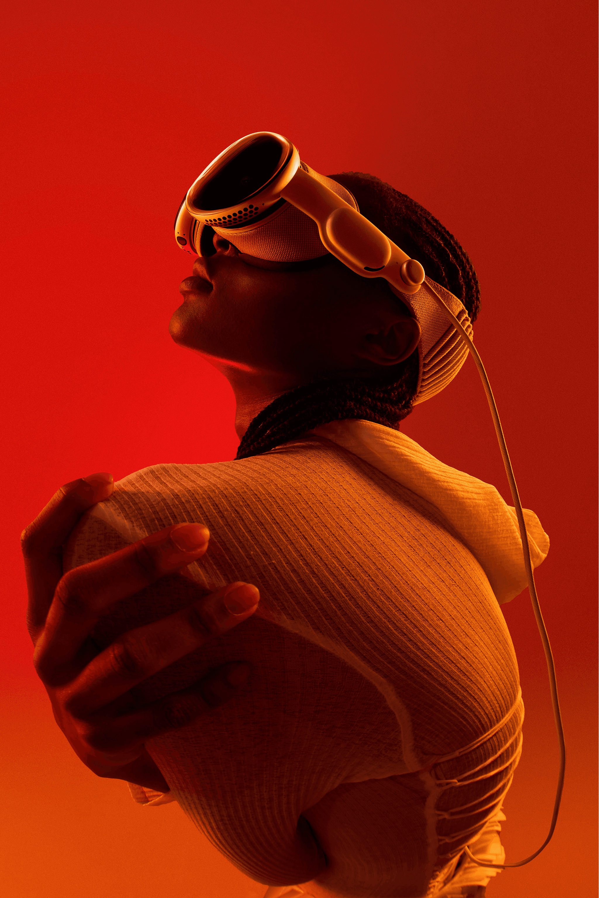 person in red background wearing a vr headset/glasses