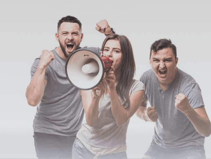Three people cheering and shouting, with one using a megaphone to amplify the noise.