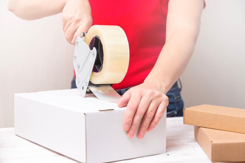 A man taping box to be kept on a local storage units, by ARENA Storage