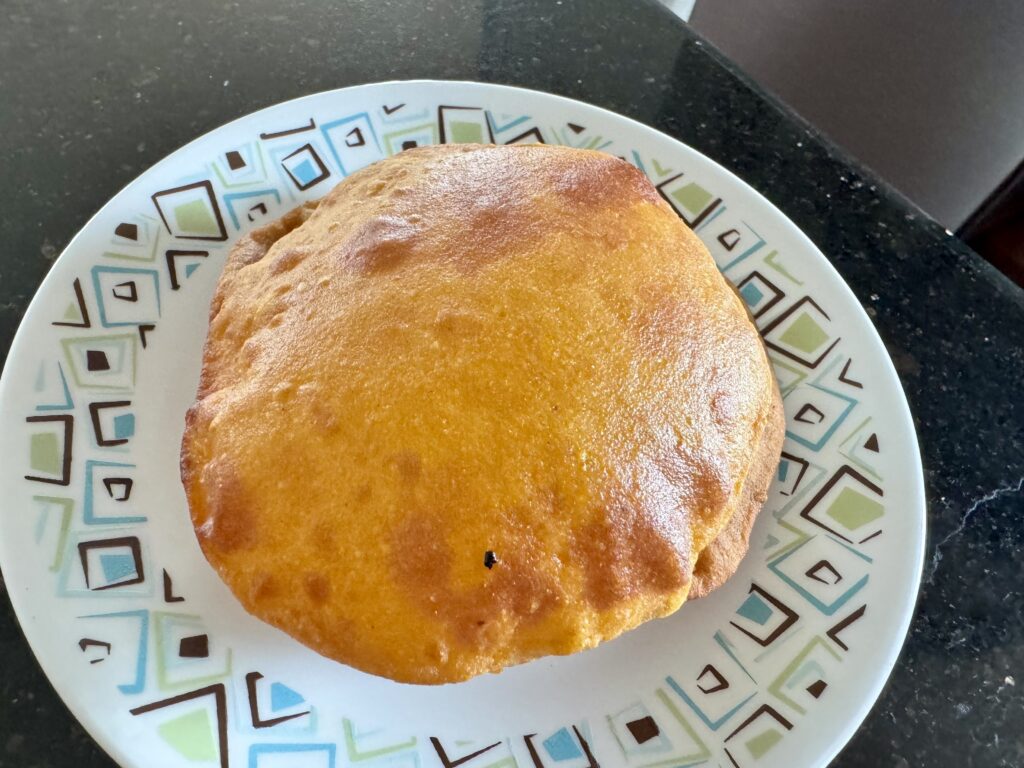 Beautifully puffed up gharge (red pumpkin puris)