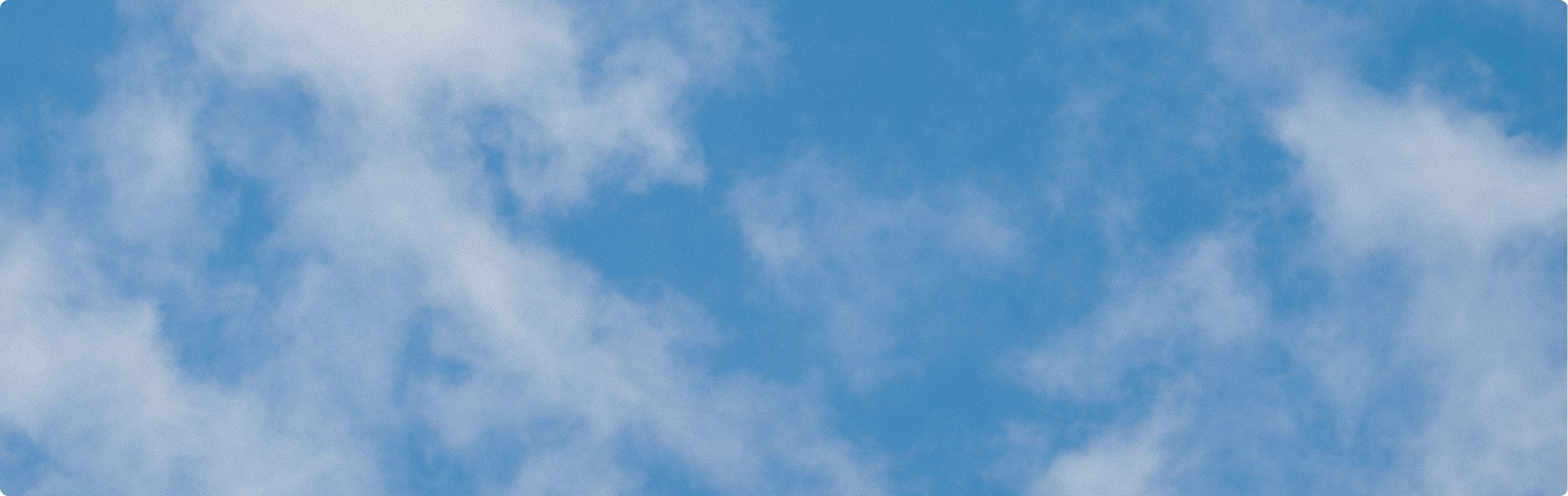 Clouds drifting across a blue sky