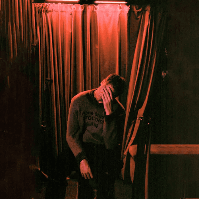 A modern brick house with a two-car garage, well-manicured lawn, and clear blue sky in the background.