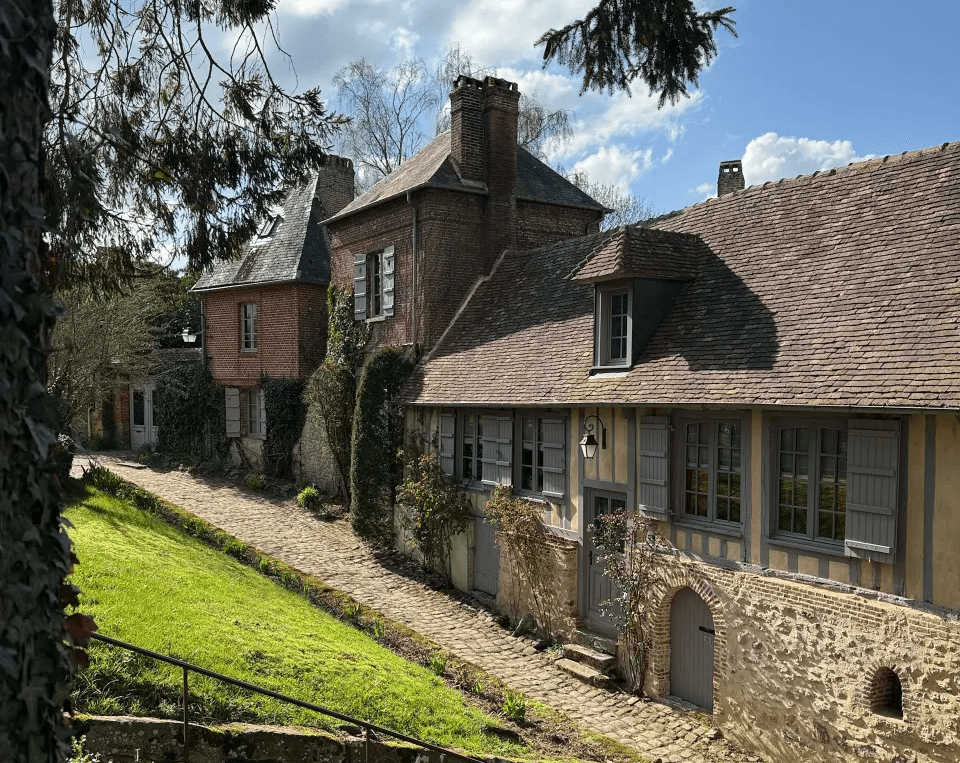 Historic brick and timber buildings along a cobbled path