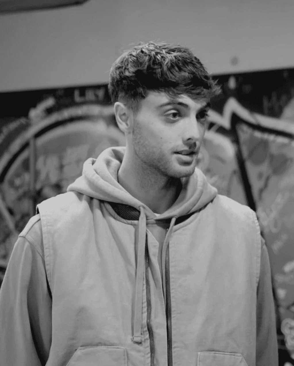 Silhouette of a camera operator filming on a professional set, surrounded by bright studio lights. The scene conveys focus and creative energy.