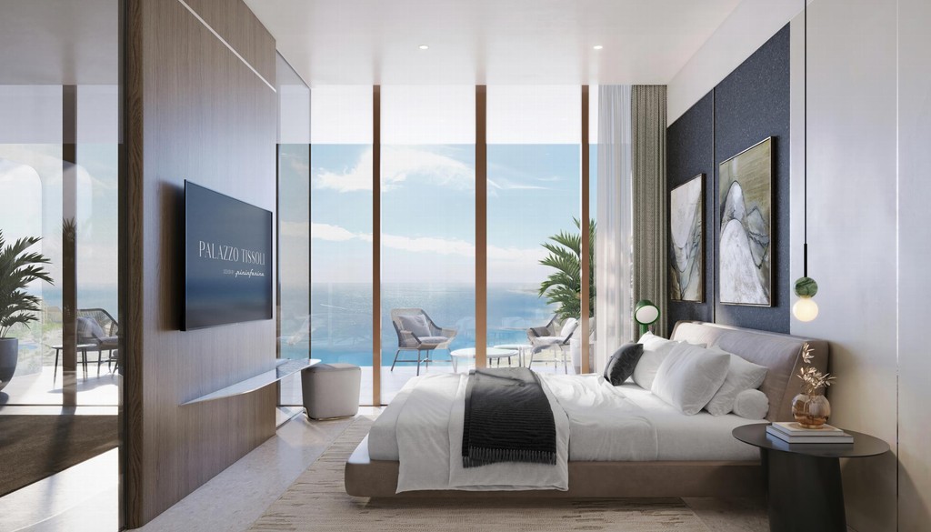 Palazzo Tissoli's modern bedroom features a spacious window with a breathtaking view of the ocean.