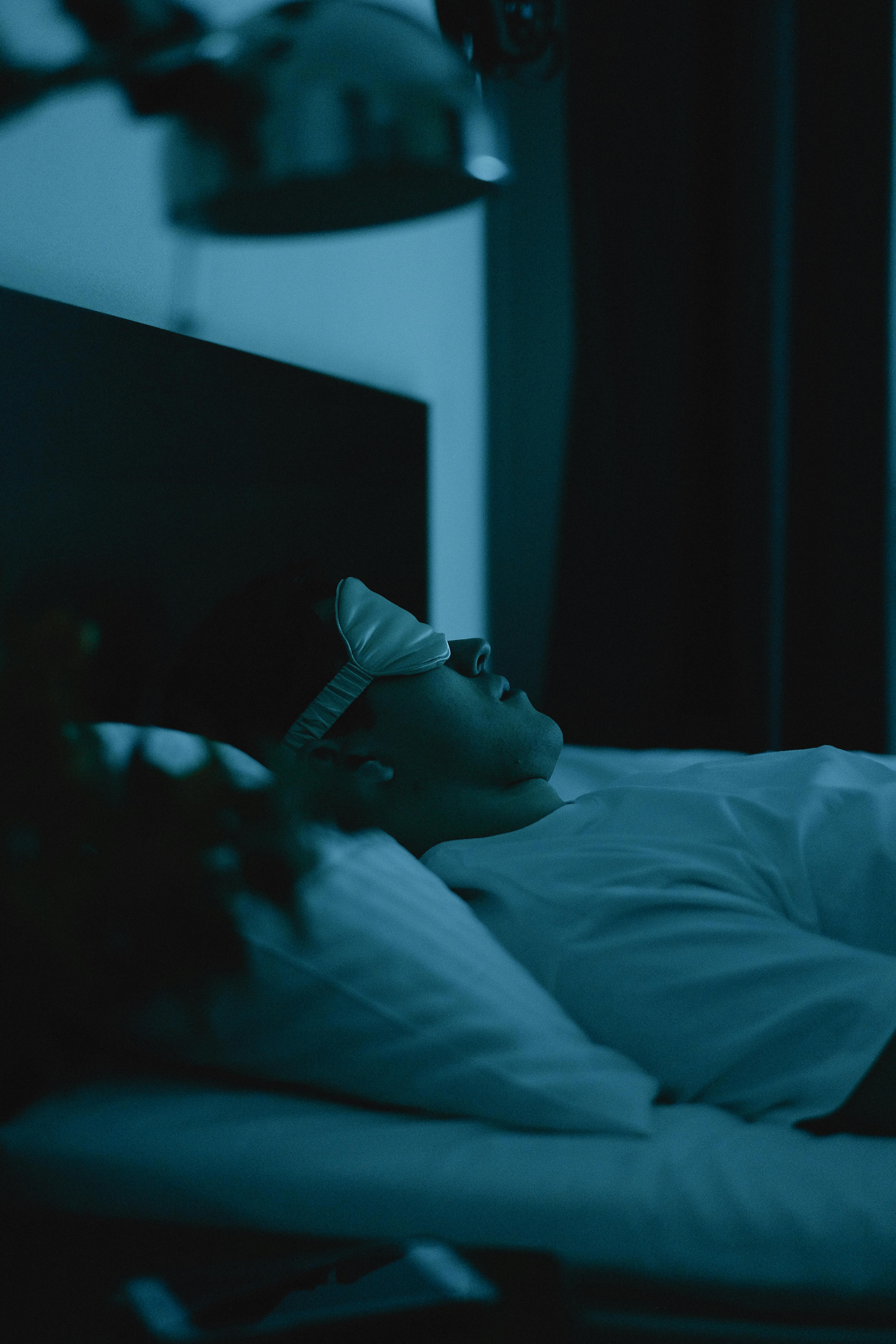 man in black tank top and black shorts lying on brown concrete floor during daytime