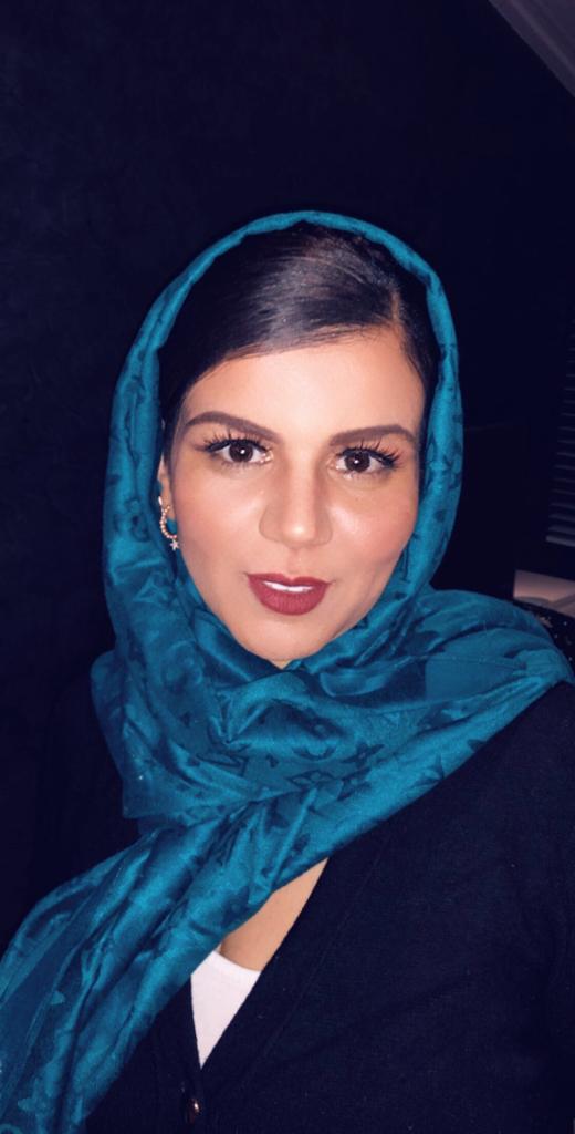 a woman sitting in a chair holding a microphone