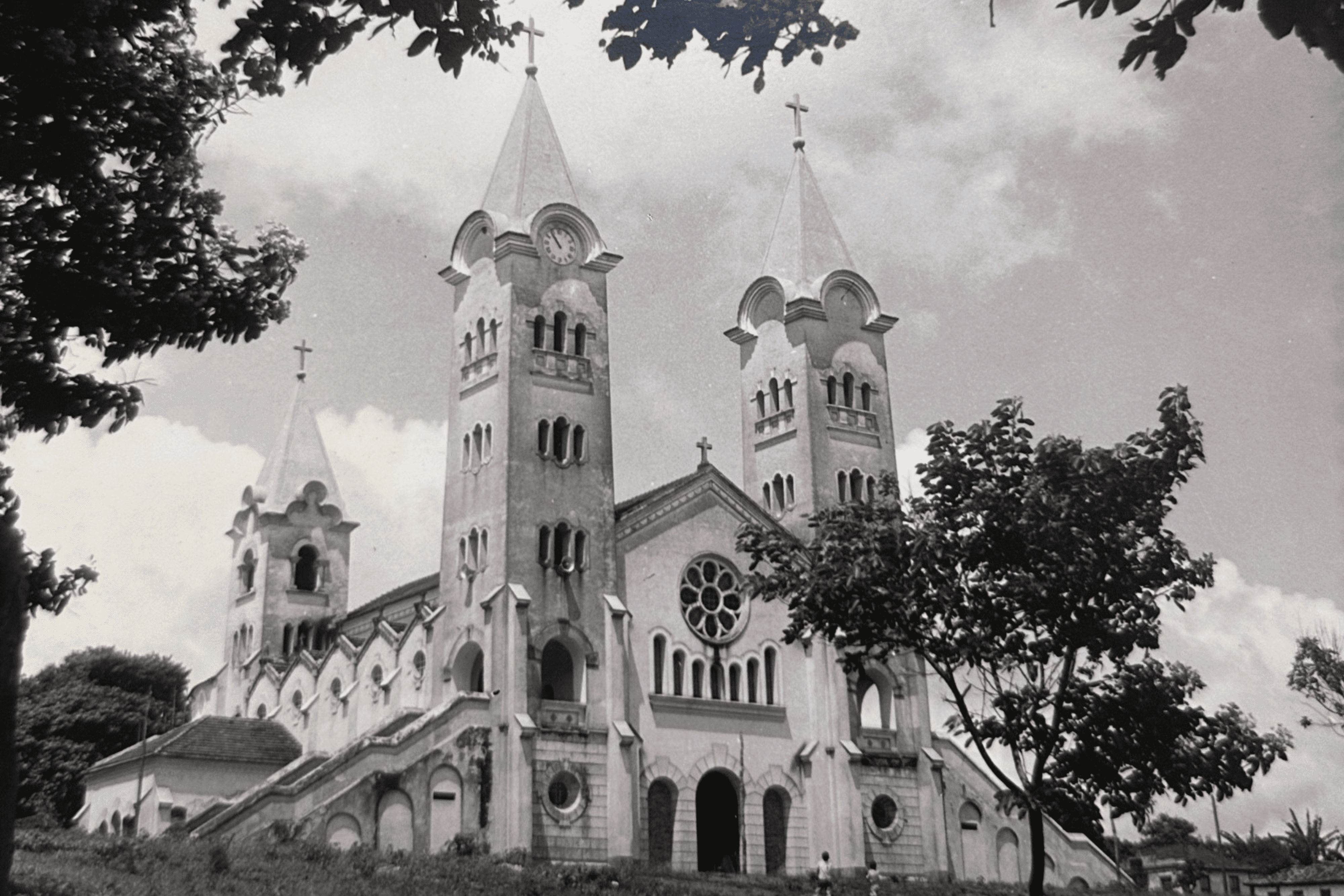 A couple joyfully celebrates in front of a rustic stone building.
