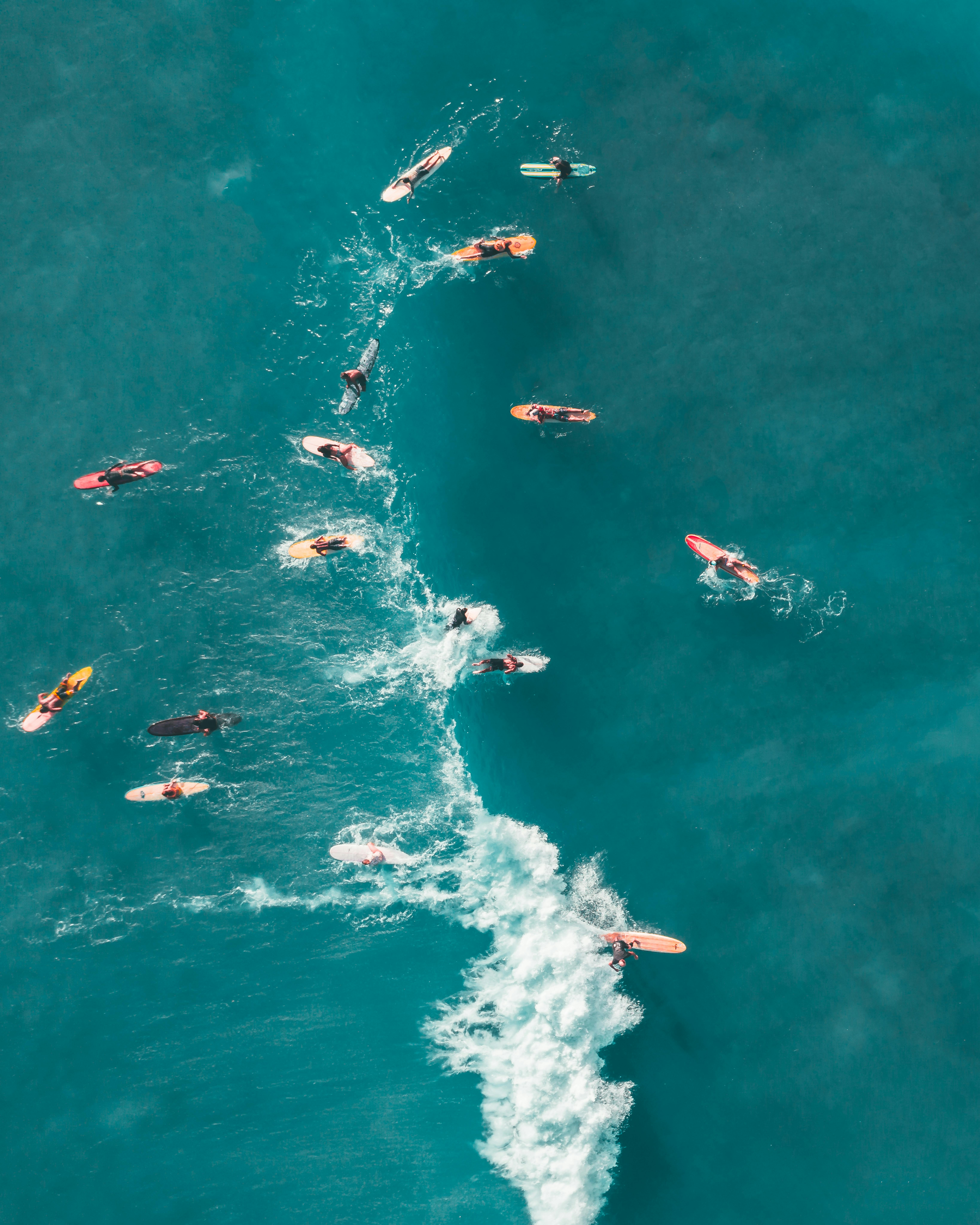 Surfer riding a powerful green wave barrel at sunset with golden sky.