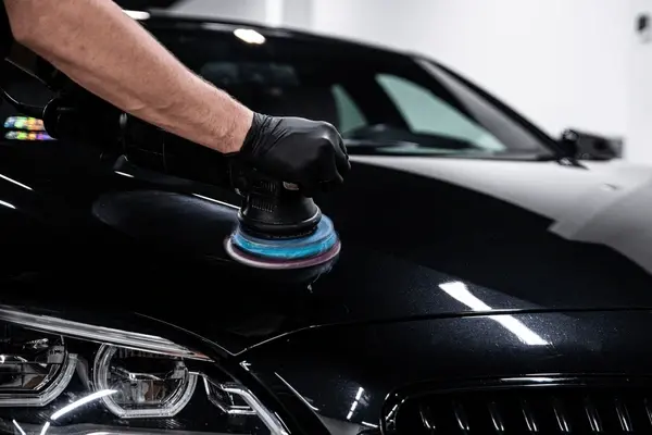 black car getting machine polished at a detail shop in kansas city