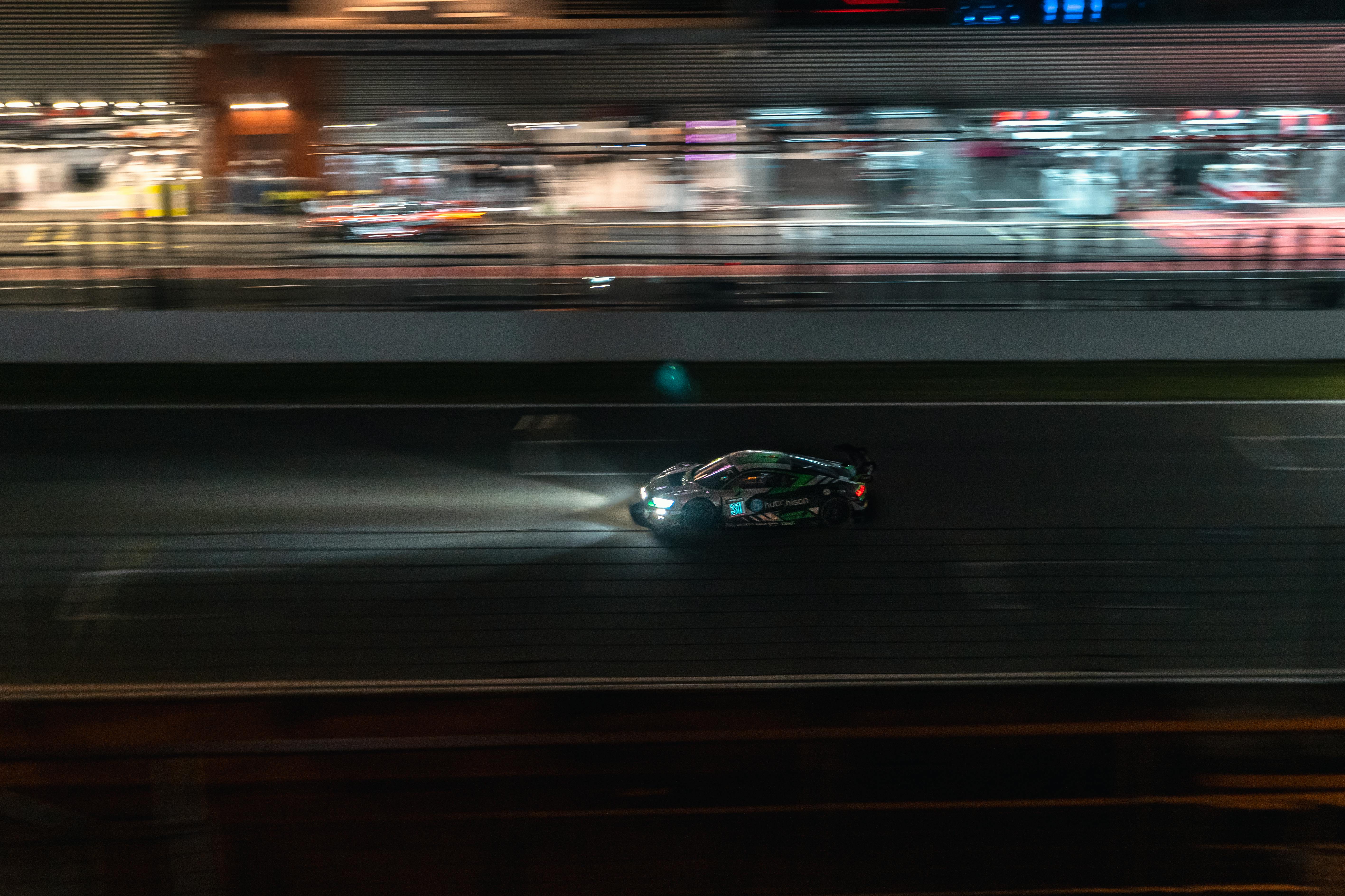 Race car on a lit track at night