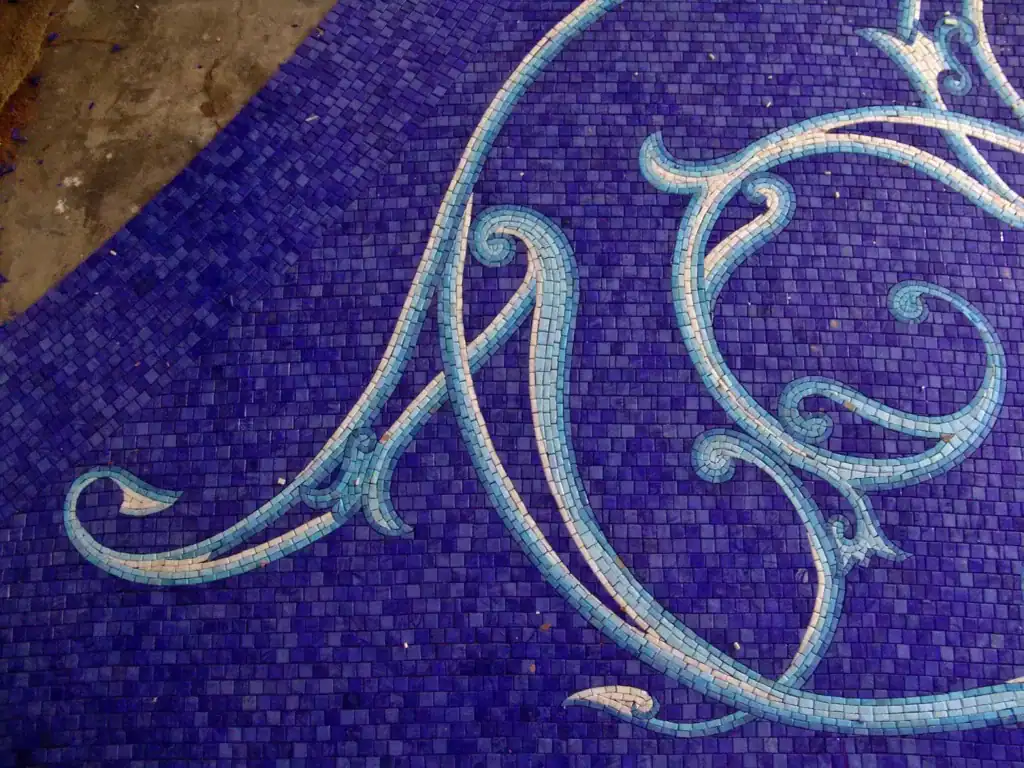 Mosaic glass pool on Naples Bay with intricate swirling patterns.