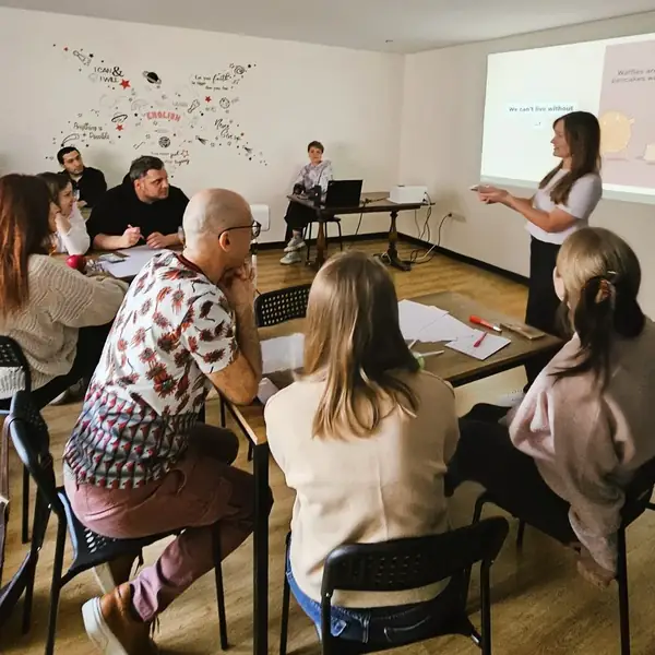 English teacher teaching adult students in a classroom