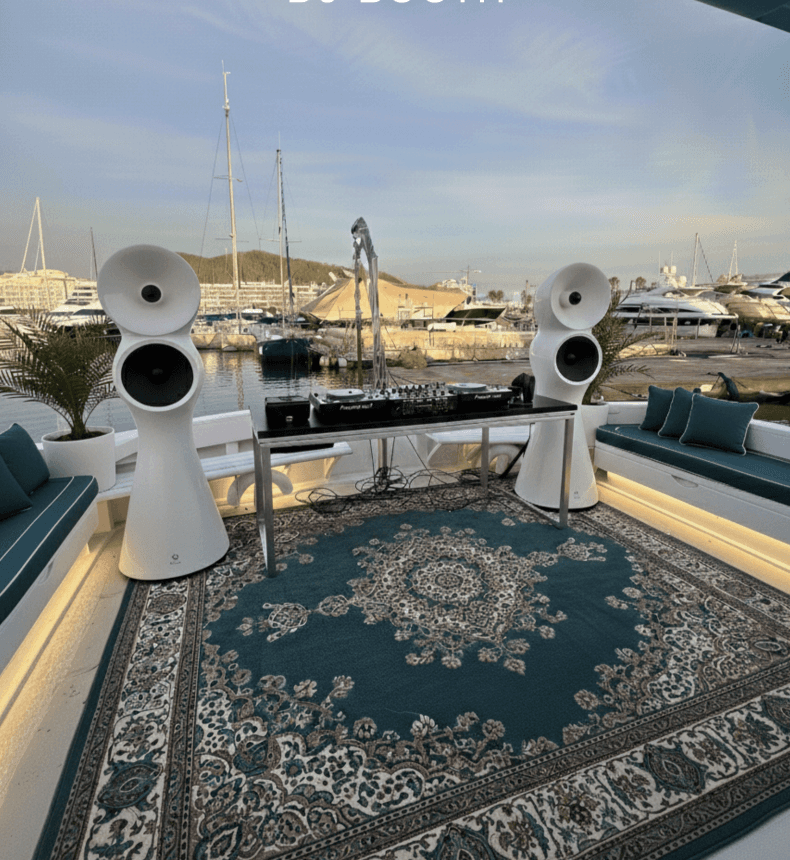 man standing near cliff looking at body of water during daytime