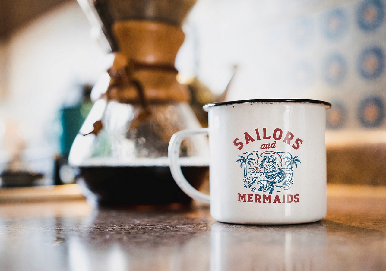 A coffee mug with a Sailors & Mermaids print