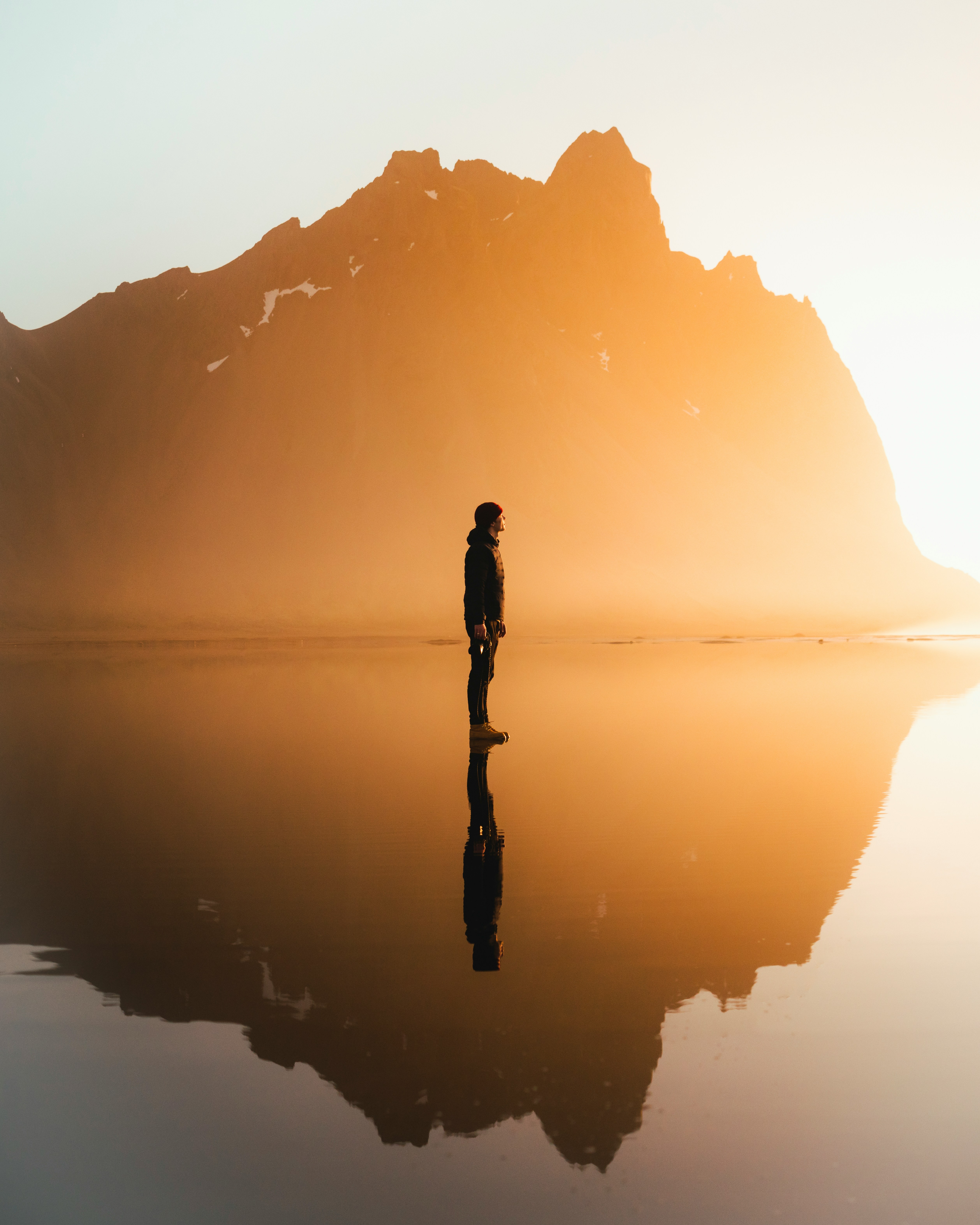 silhouette of woman standing on water during daytime