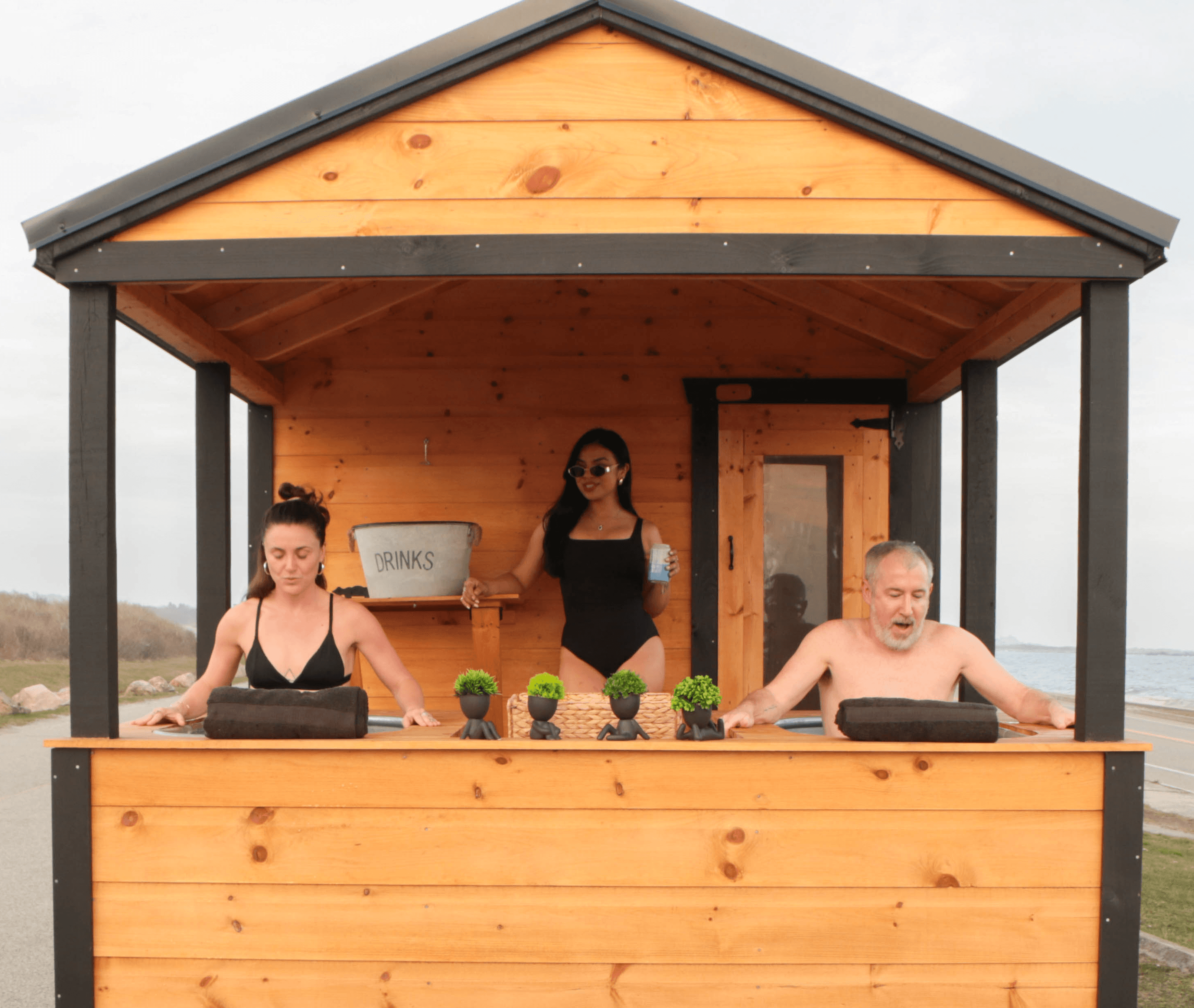 Outdoor cold plunge tubs beside a mobile sauna used for contrast therapy and recovery in Newport County, Rhode Island.