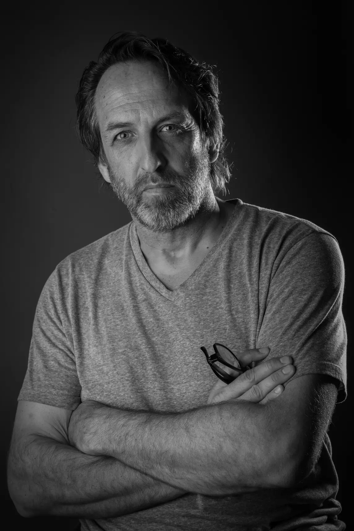 Black-and-white portrait of a Meridian Studio team member with arms crossed