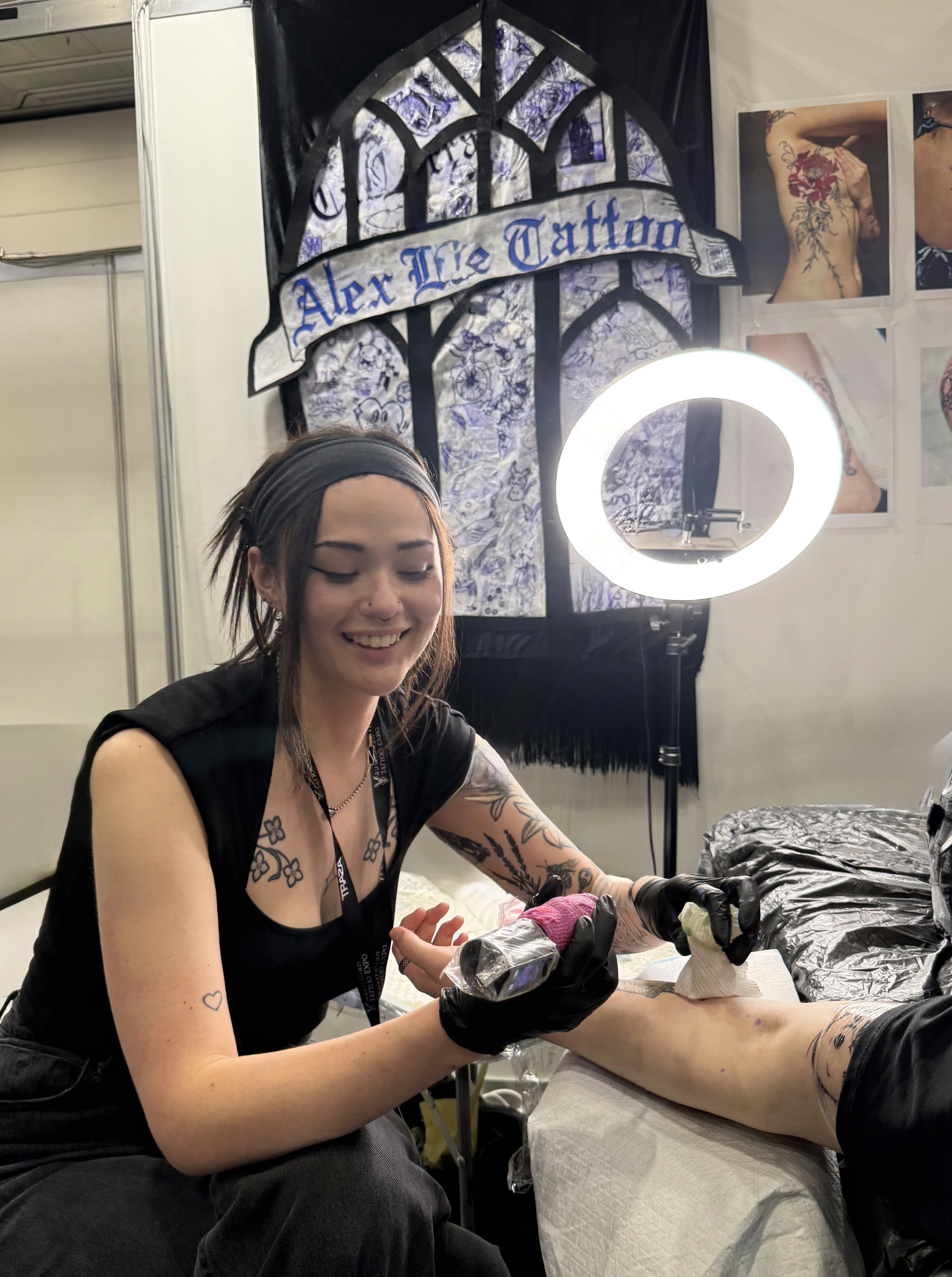 Tattoo artist working on a client in a professional studio