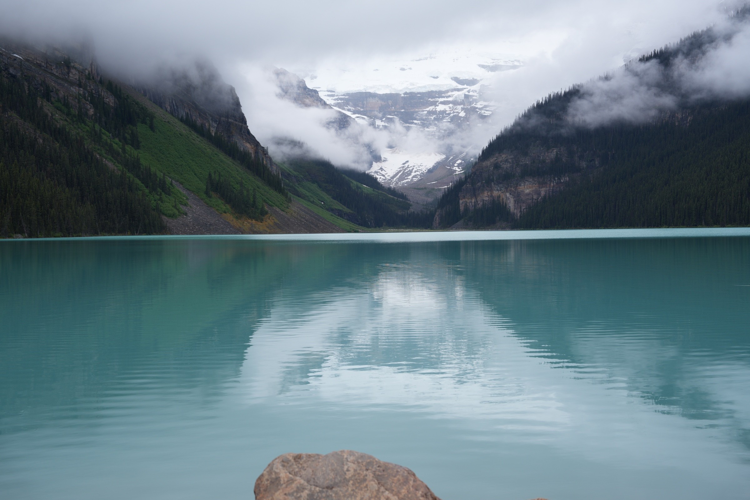Lake Louise below cloud-covered peaks in Banff National Park