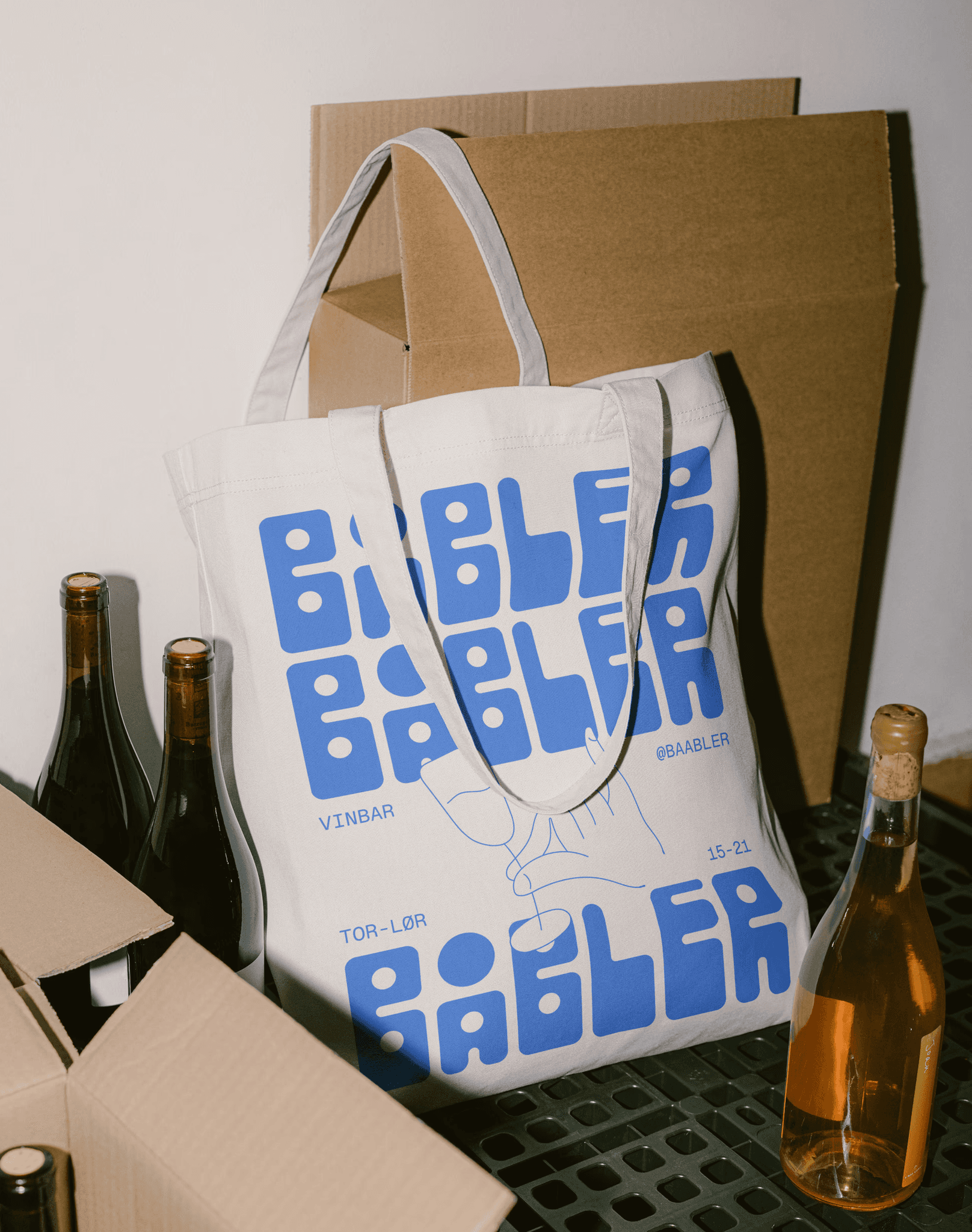 A tote bag designed for Båbler standing in a wine storage.