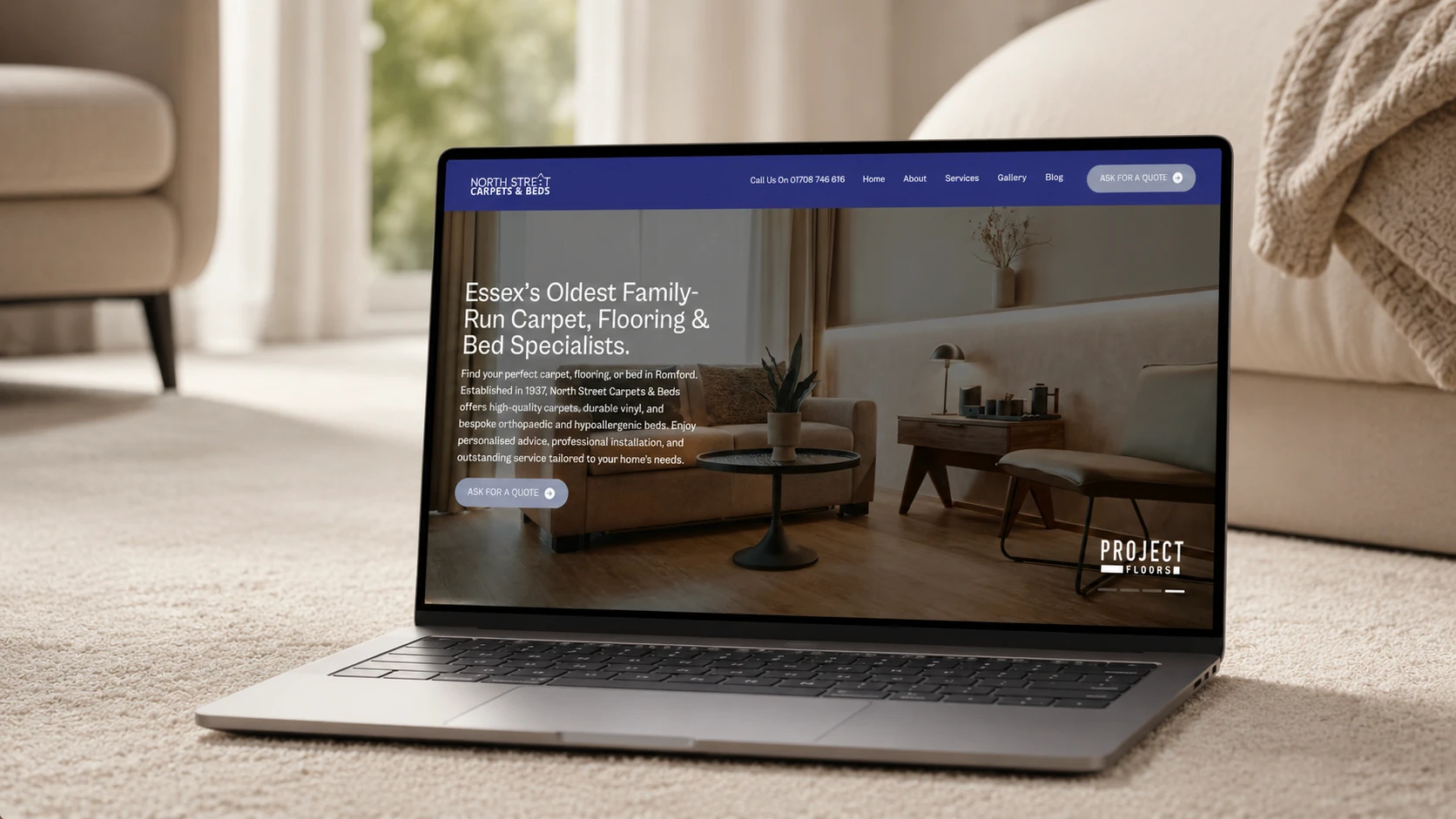 Laptop displaying "Essex's Oldest Family-Run Carpet, Flooring & Bed Specialists"