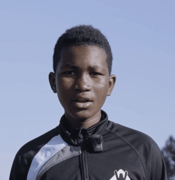 man wearing green crew-neck top and eyeglasses with black frames looking at side