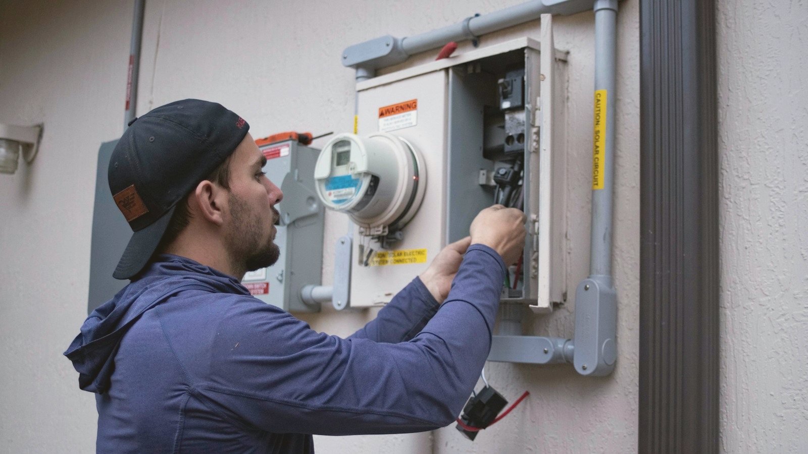 Technician checking an electric meter
