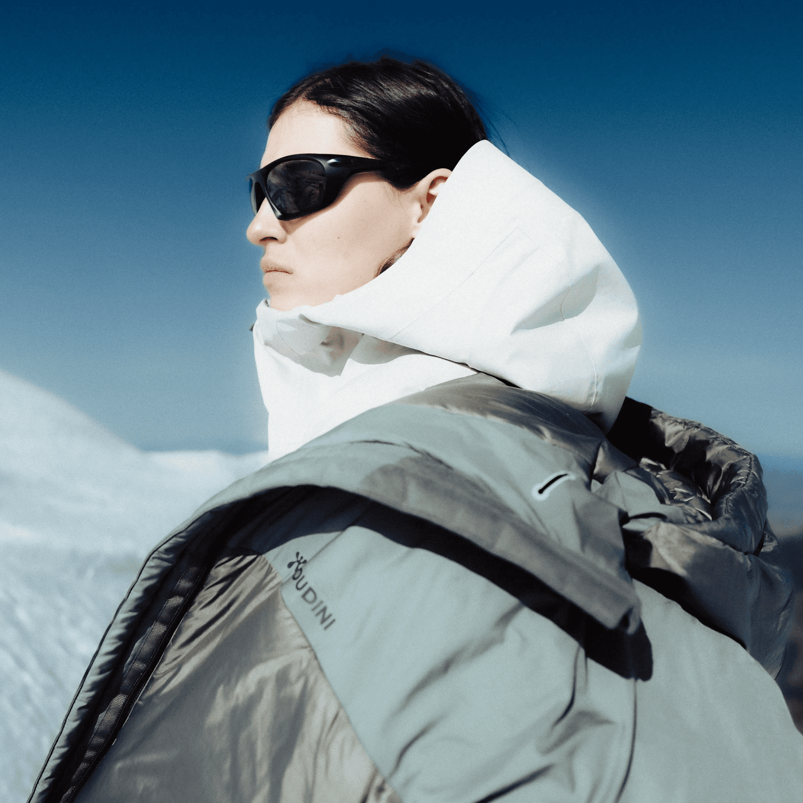 shot of a sport model, wearing puffer jacket and sport glasses.