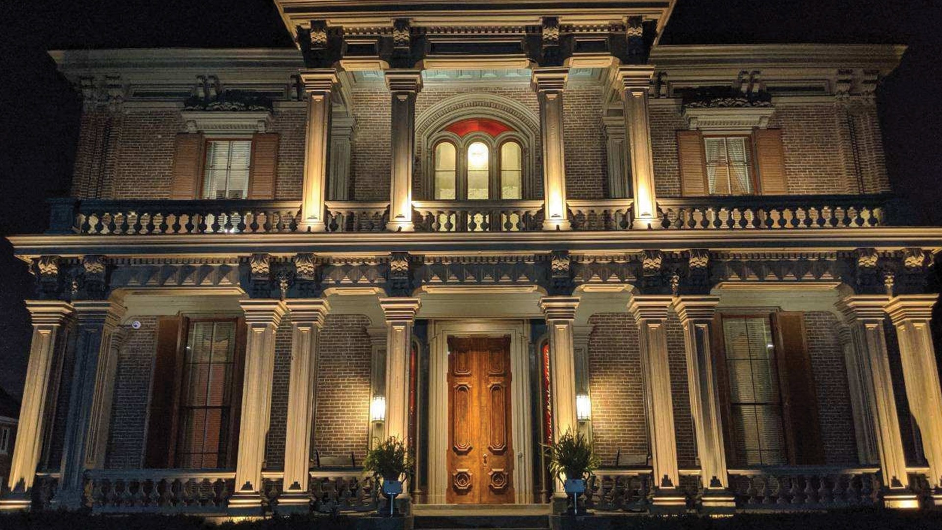 Two Rivers Mansion entrance illuminated at night