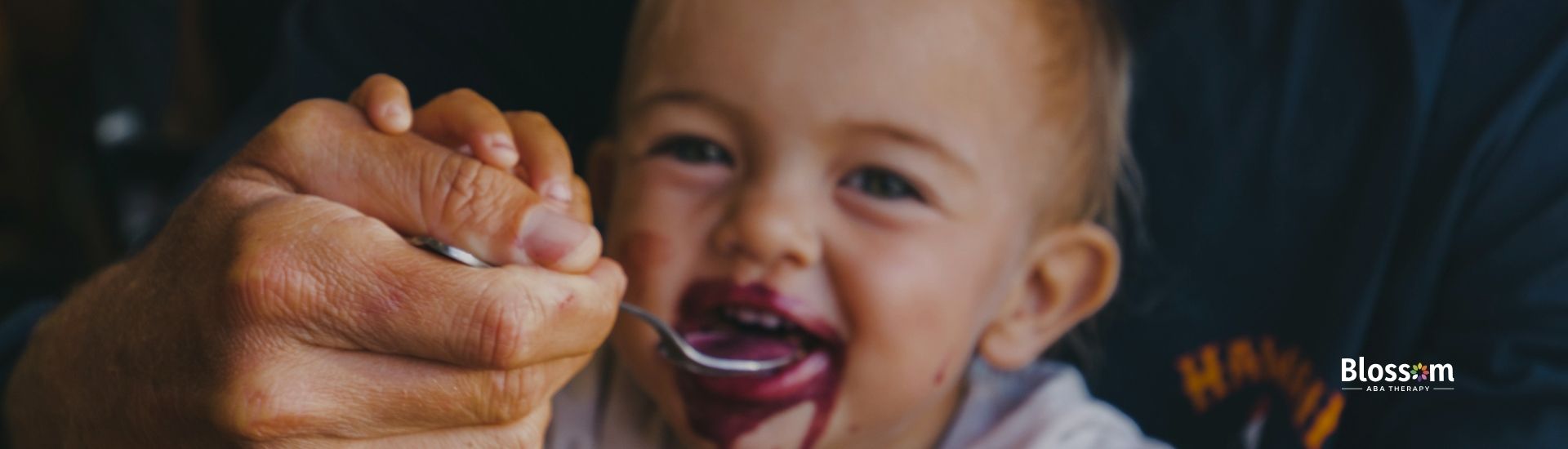 A baby boy being fed by his father.