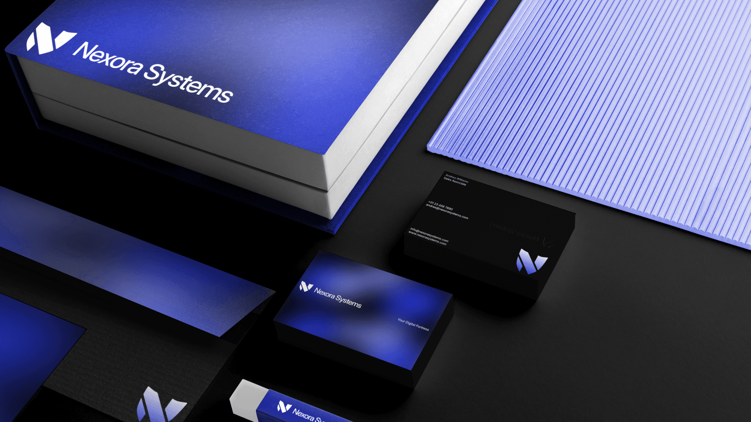 Corporate stationery design for Nexora Systems. The image features a book, an envelope, and two stacks of business cards.