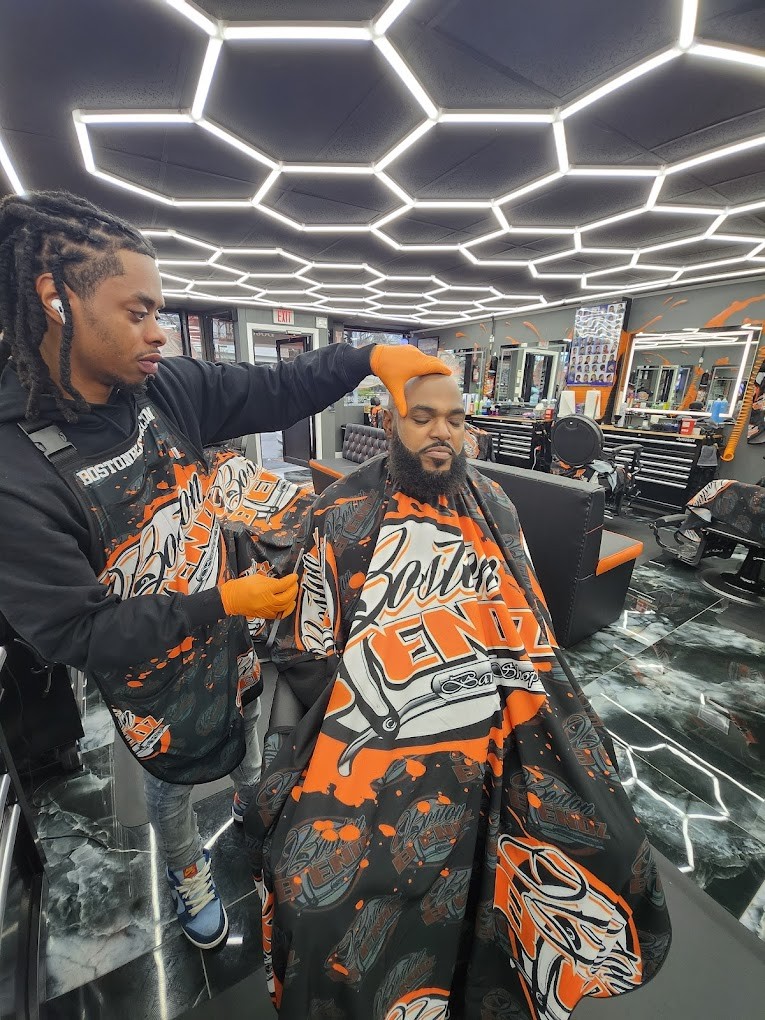 Barber cutting persons hair