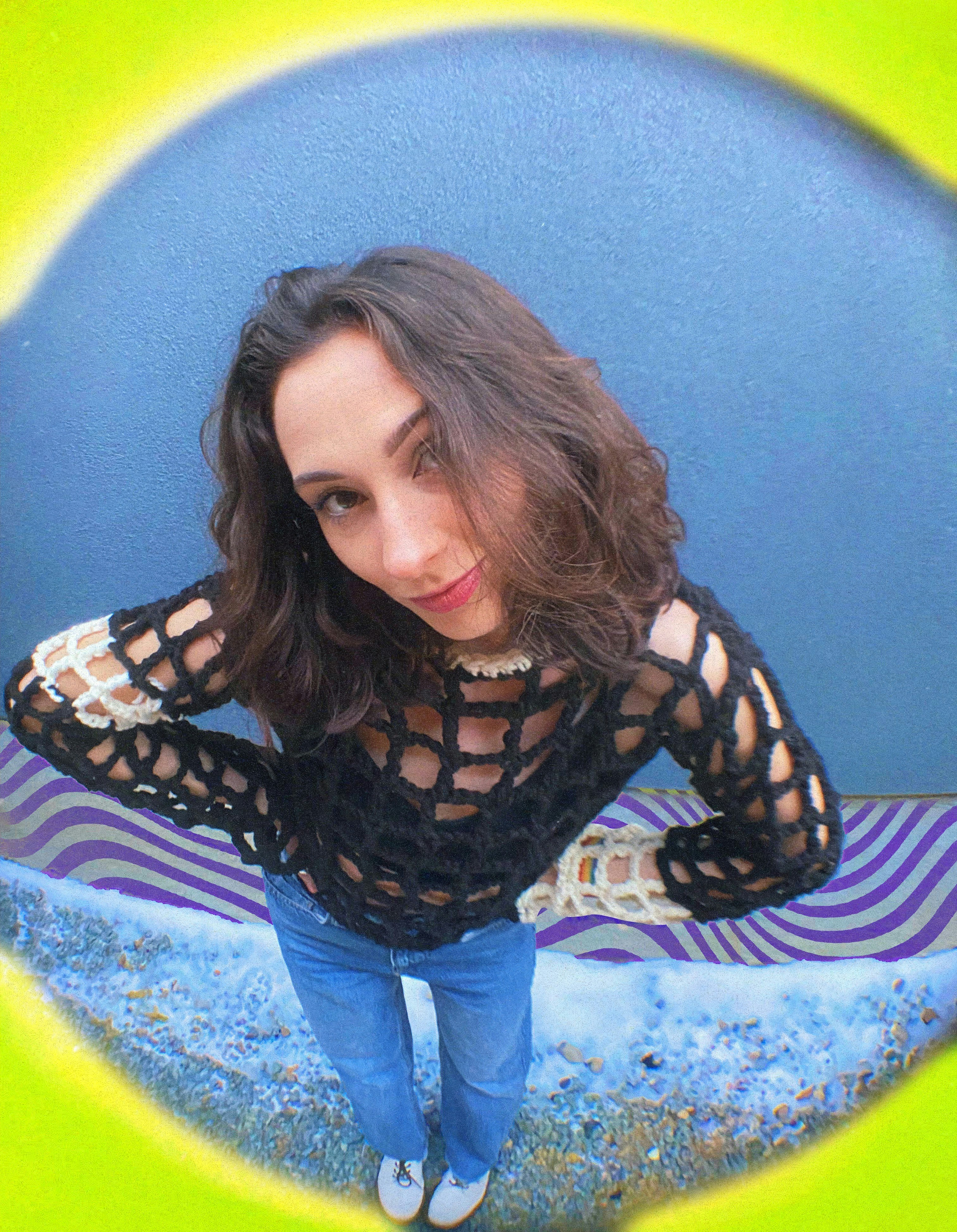 a gen z woman standing in front of a blue wall