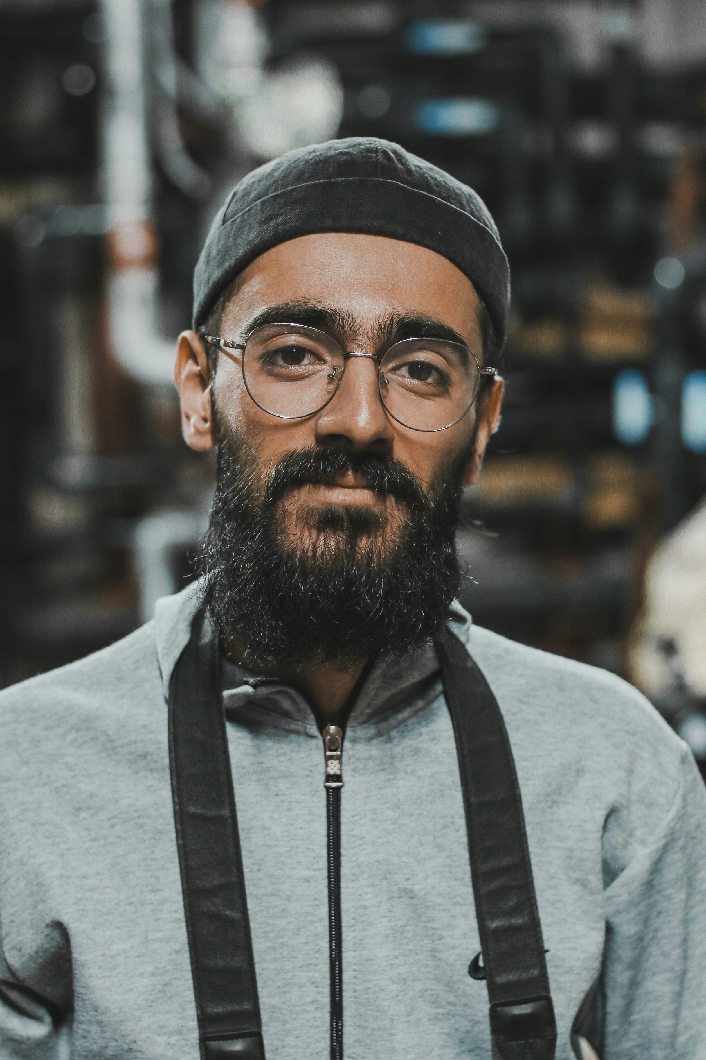 a man with a beard wearing glasses and a hat