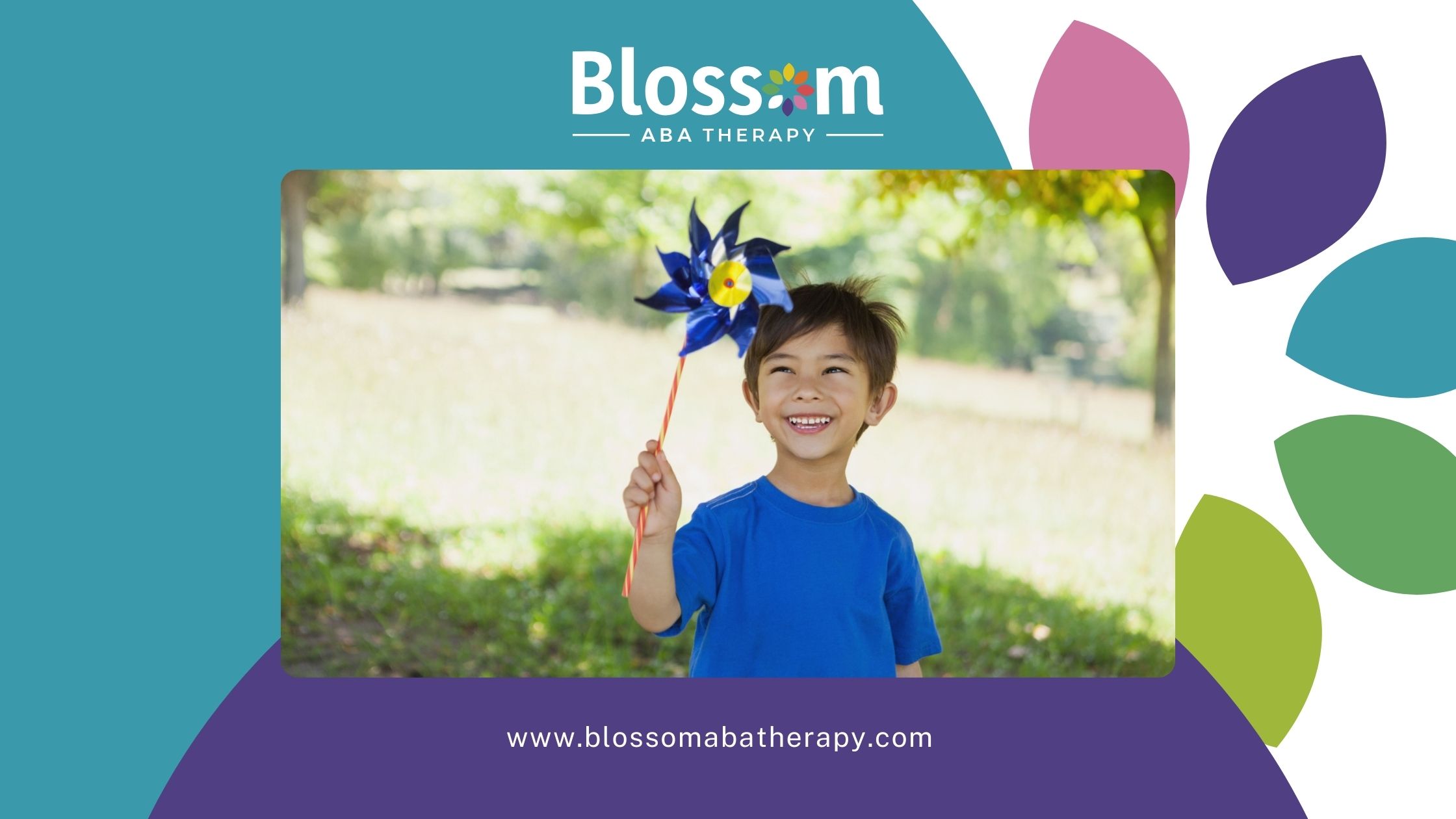 Child smiling while holding a colorful pinwheel in a park.