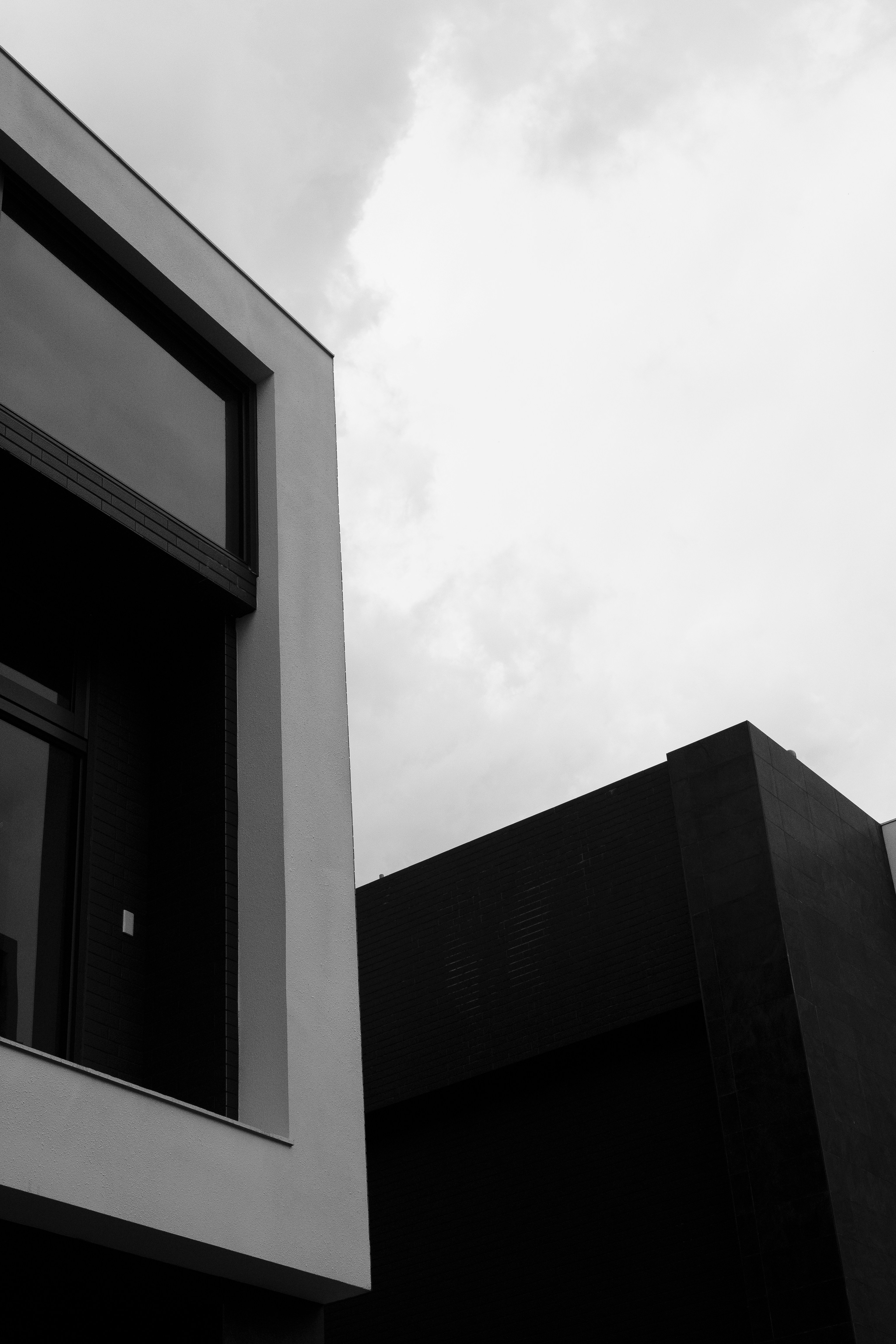 A black and white photo of a building and a clock