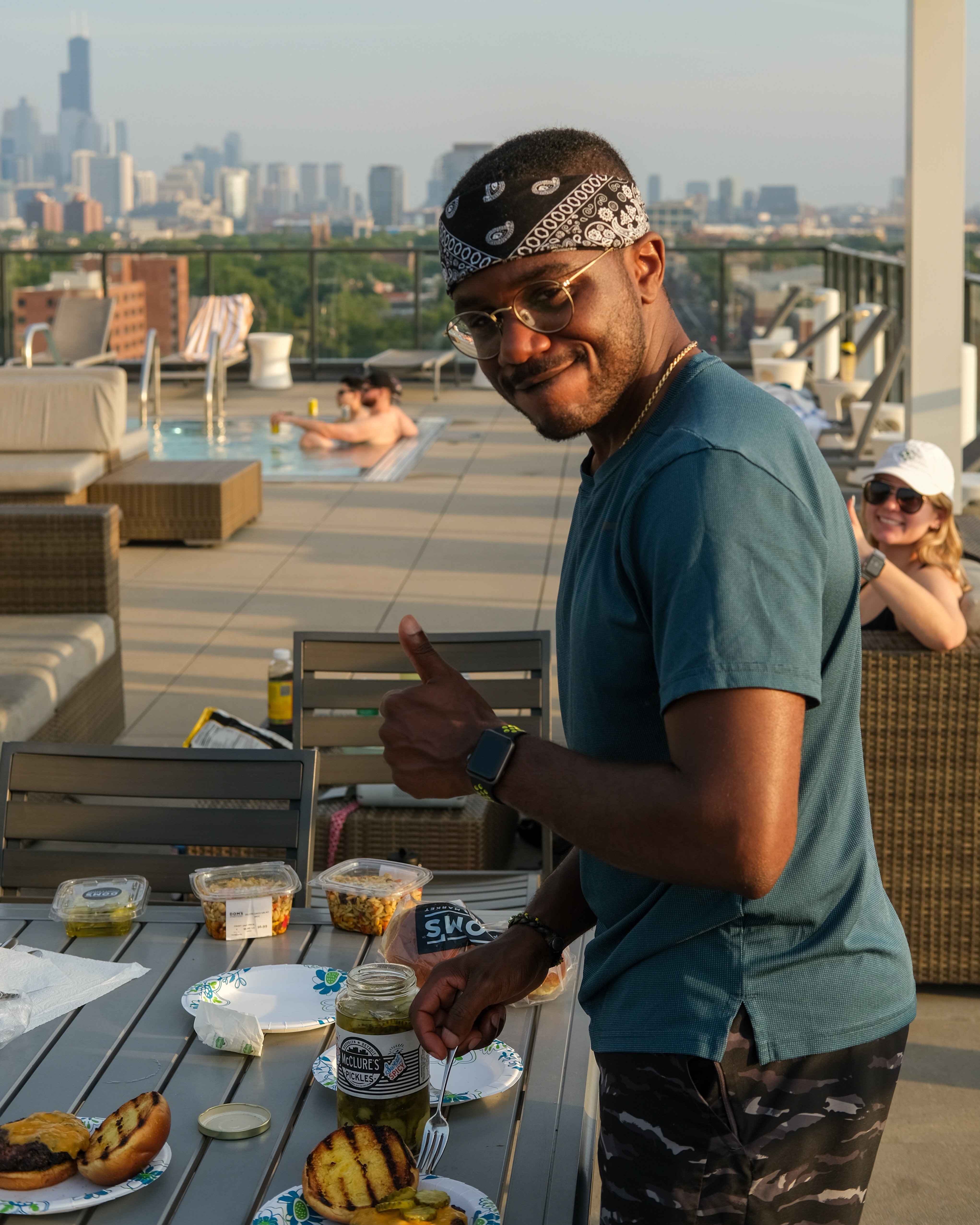 A photo of Aman and friends having a rooftop BBQ session.