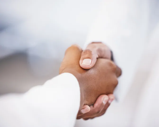 Two hands in an elegant gesture, one above the other, against a dark background