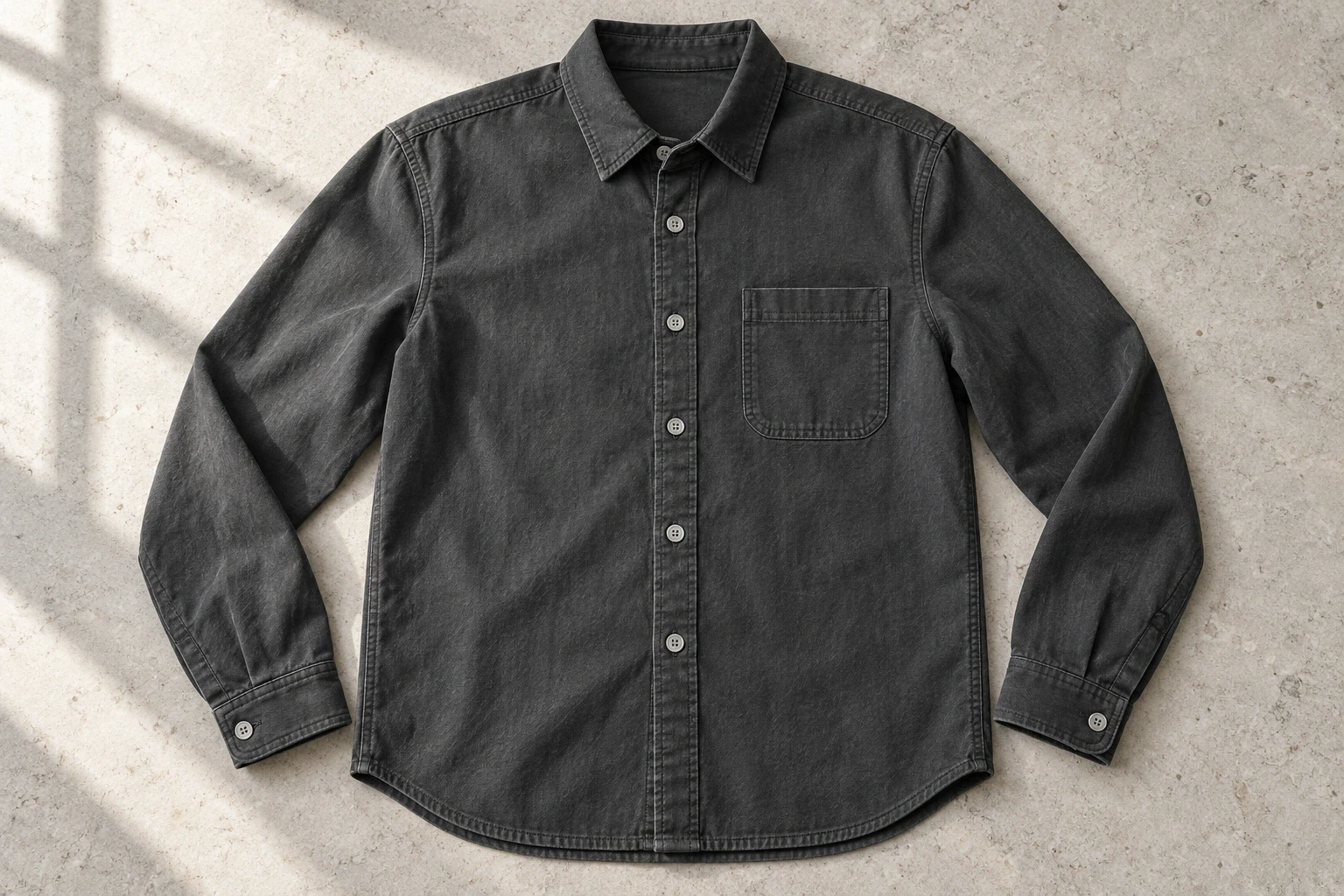 Charcoal button-front shirt laid flat with a patch pocket and both cuffs visible