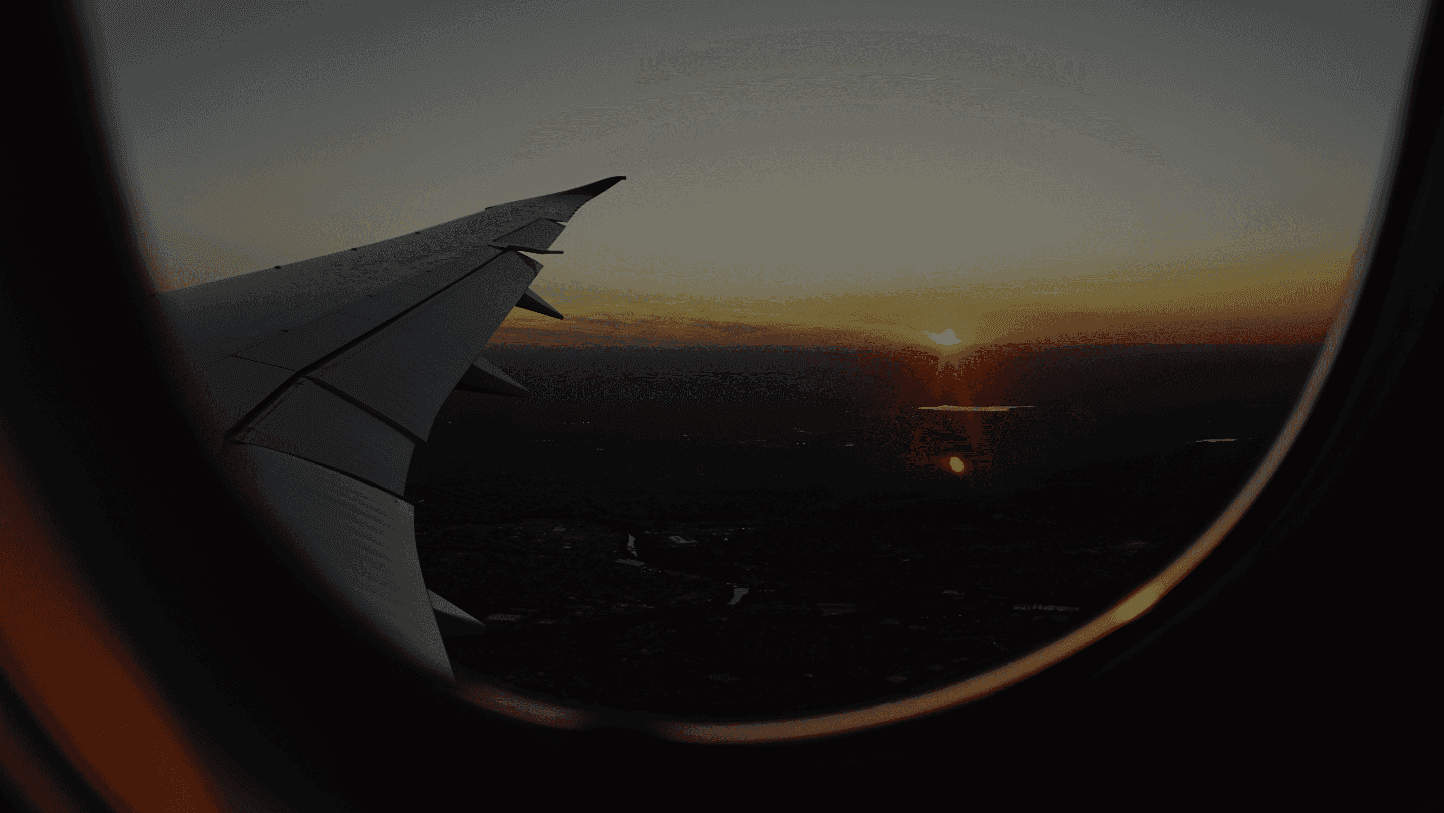 airplanes window view of sky during golden hour