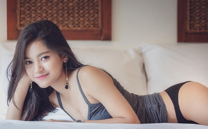 kids lying on a glass land and smiling