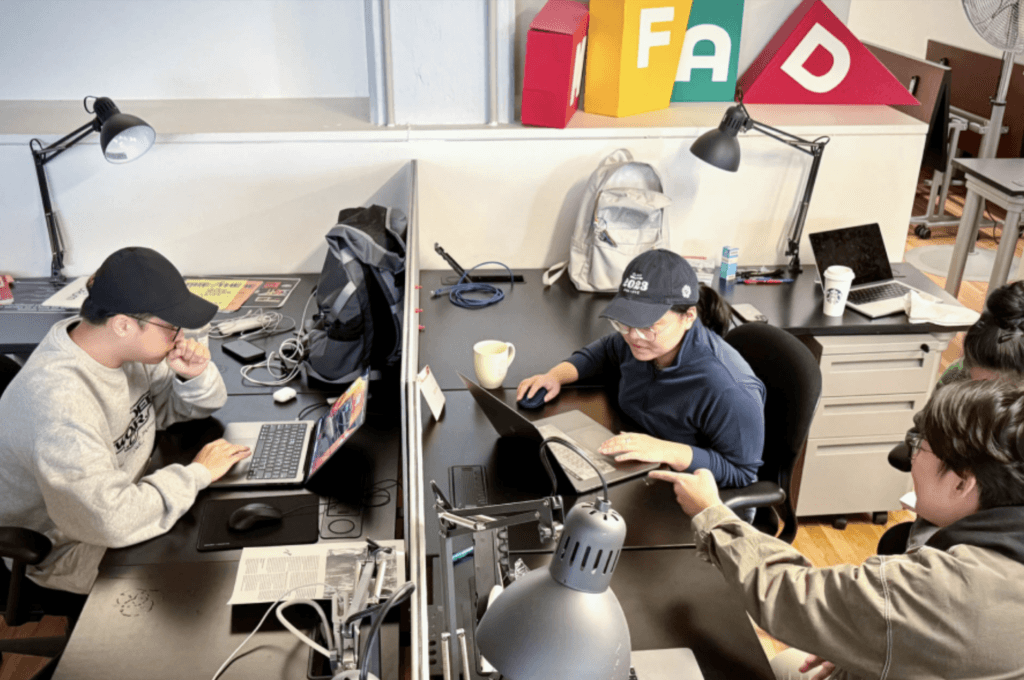 students working at their desks in the studio