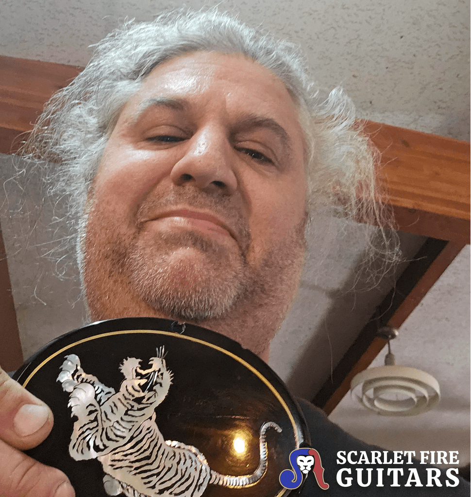 Leo Elliot holding the original Tiger emblem from Jerry Garcia's Tiger guitar