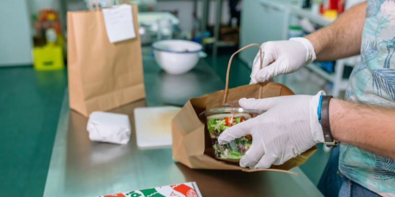 An F&B staff packing an order