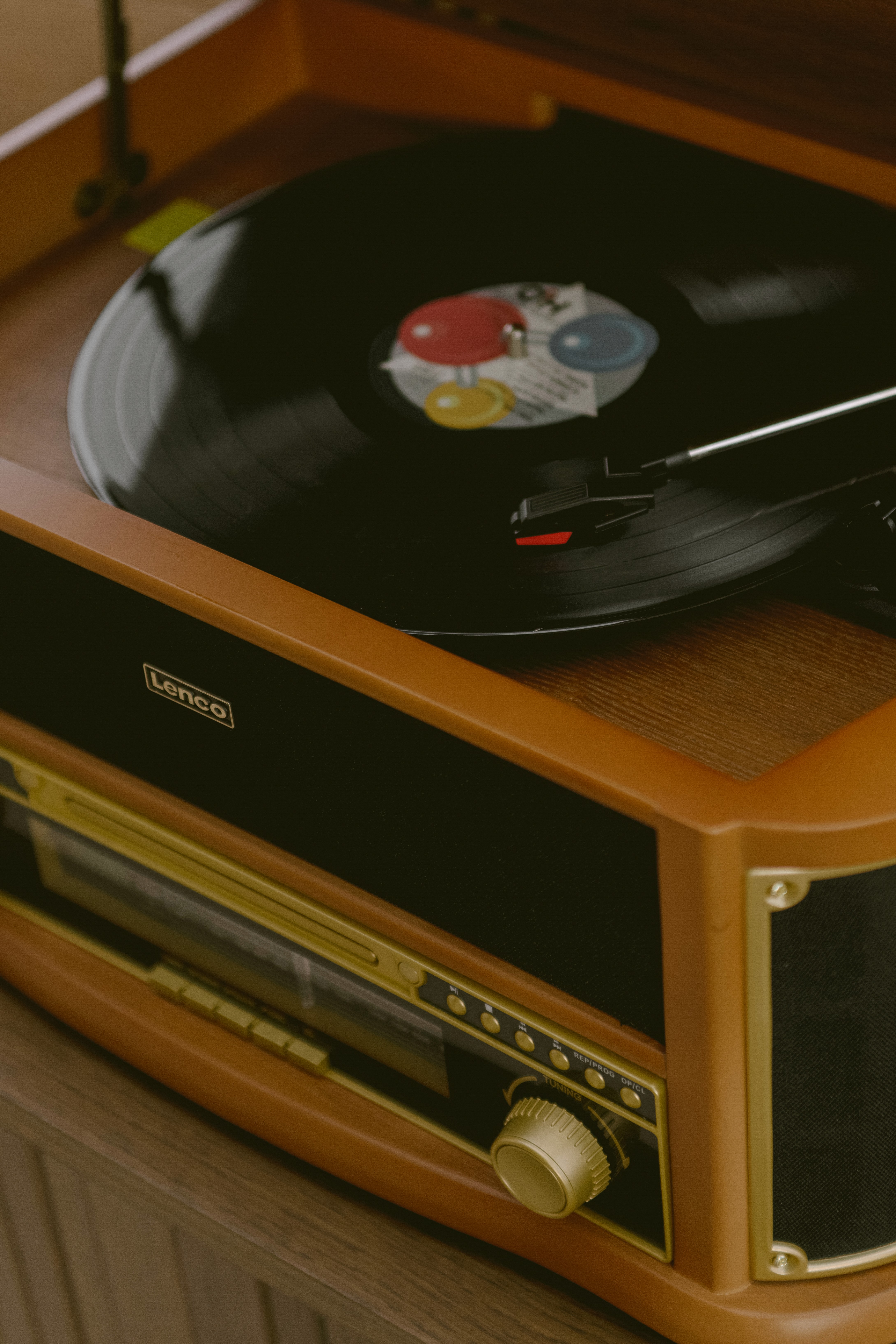 Vintage Lenco turntable and radio playing a vinyl record, styled as a design feature within a modern luxury cabin interior.