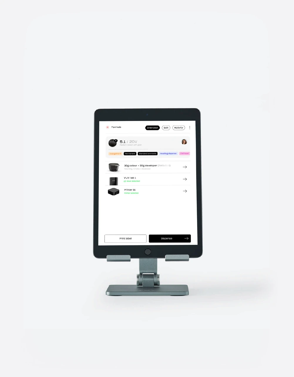 The iPad on a stand displaying the yuv® App which shows a hair colour formula card. 